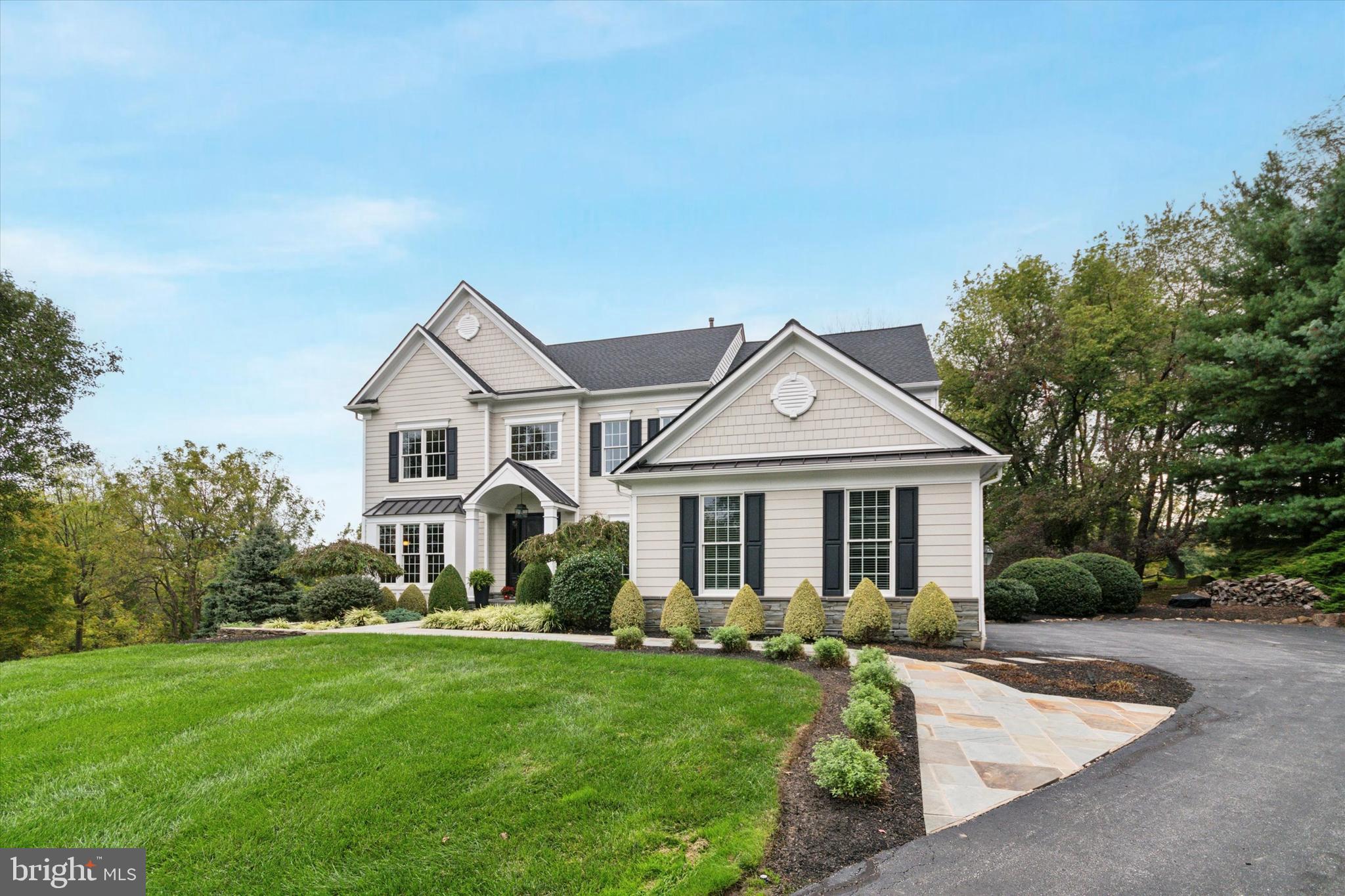 1007 Ridgehaven Road West Chester, PA 19382 - Photo 2 of 36 a front view of a house with a garden