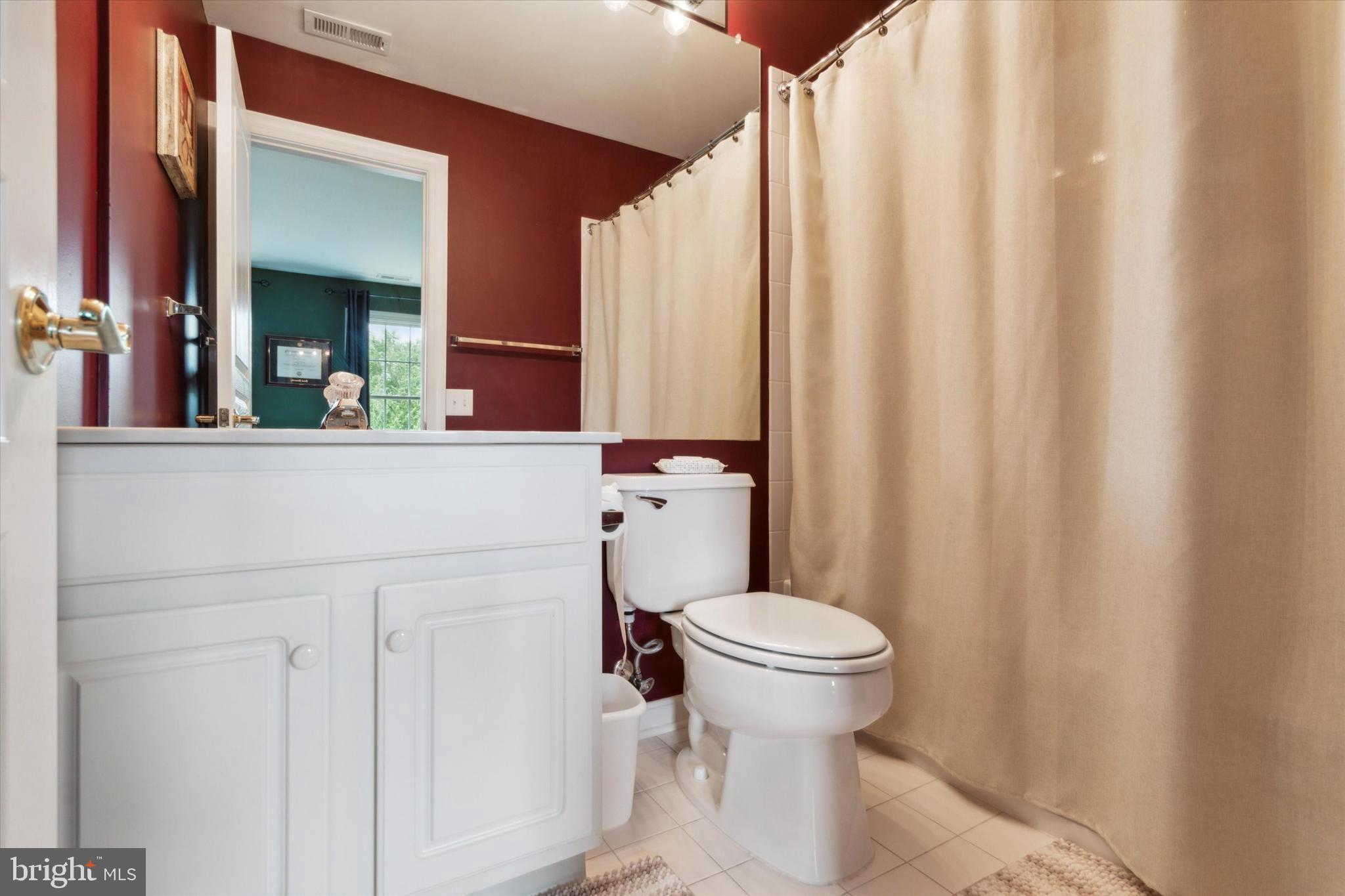 1007 Ridgehaven Road West Chester, PA 19382 - Photo 26 of 36 a bathroom with a sink a toilet and shower curtain