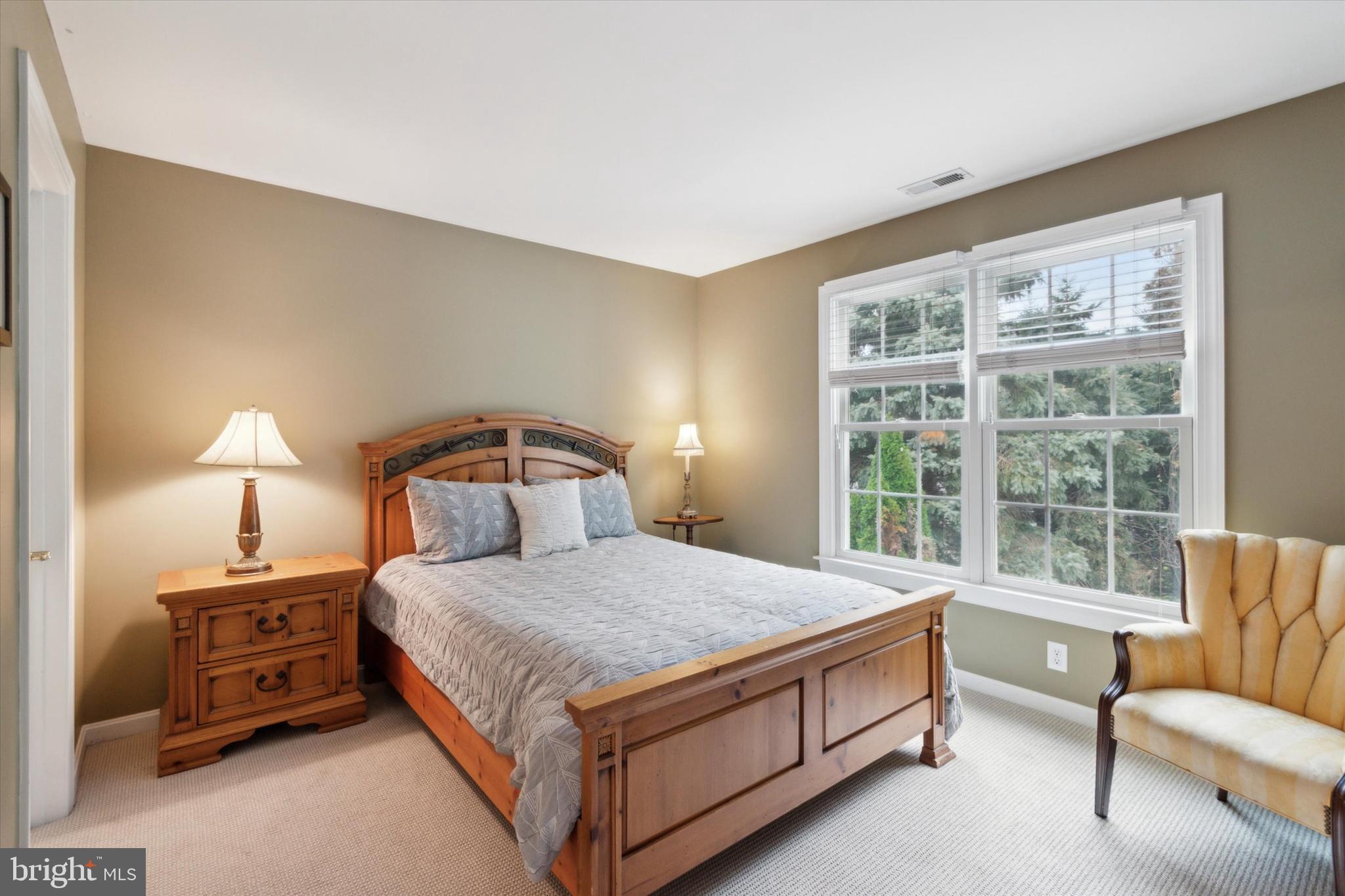 1007 Ridgehaven Road West Chester, PA 19382 - Photo 27 of 36 a bedroom with a bed and a couch next to a window