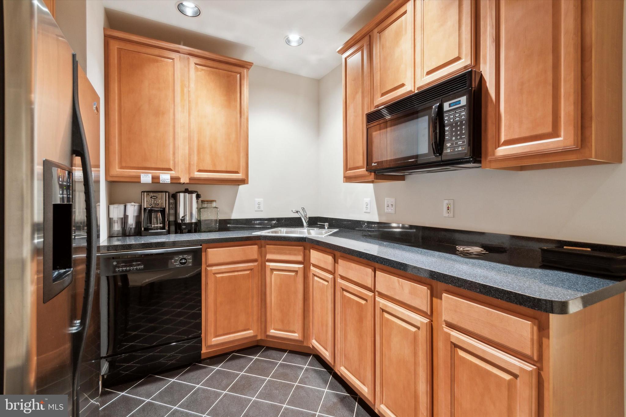 1007 Ridgehaven Road West Chester, PA 19382 - Photo 33 of 36 a kitchen with stainless steel appliances granite countertop a stove a sink and a microwave