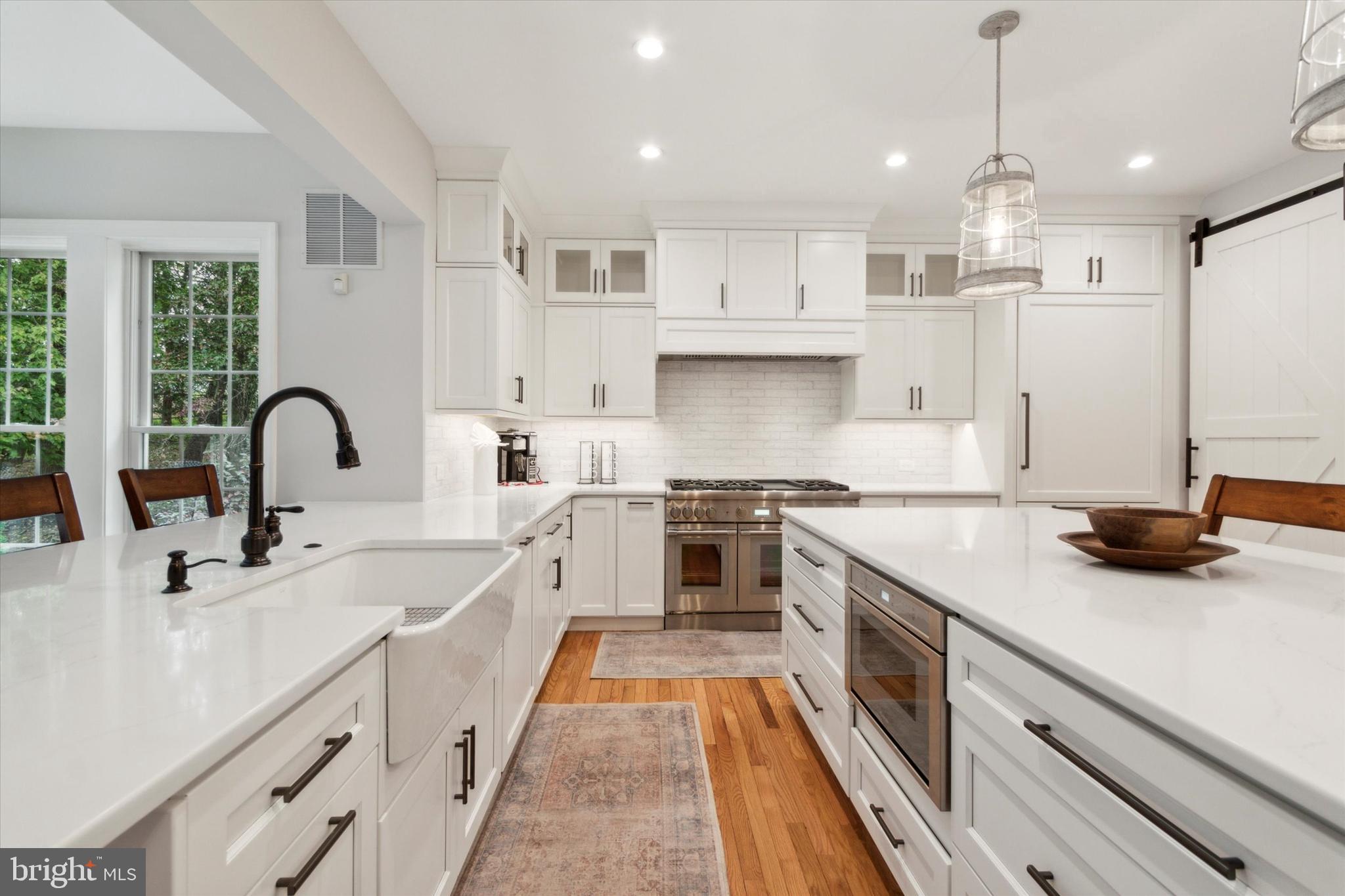 1007 Ridgehaven Road West Chester, PA 19382 - Photo 7 of 36 a kitchen with kitchen island white cabinets and appliances