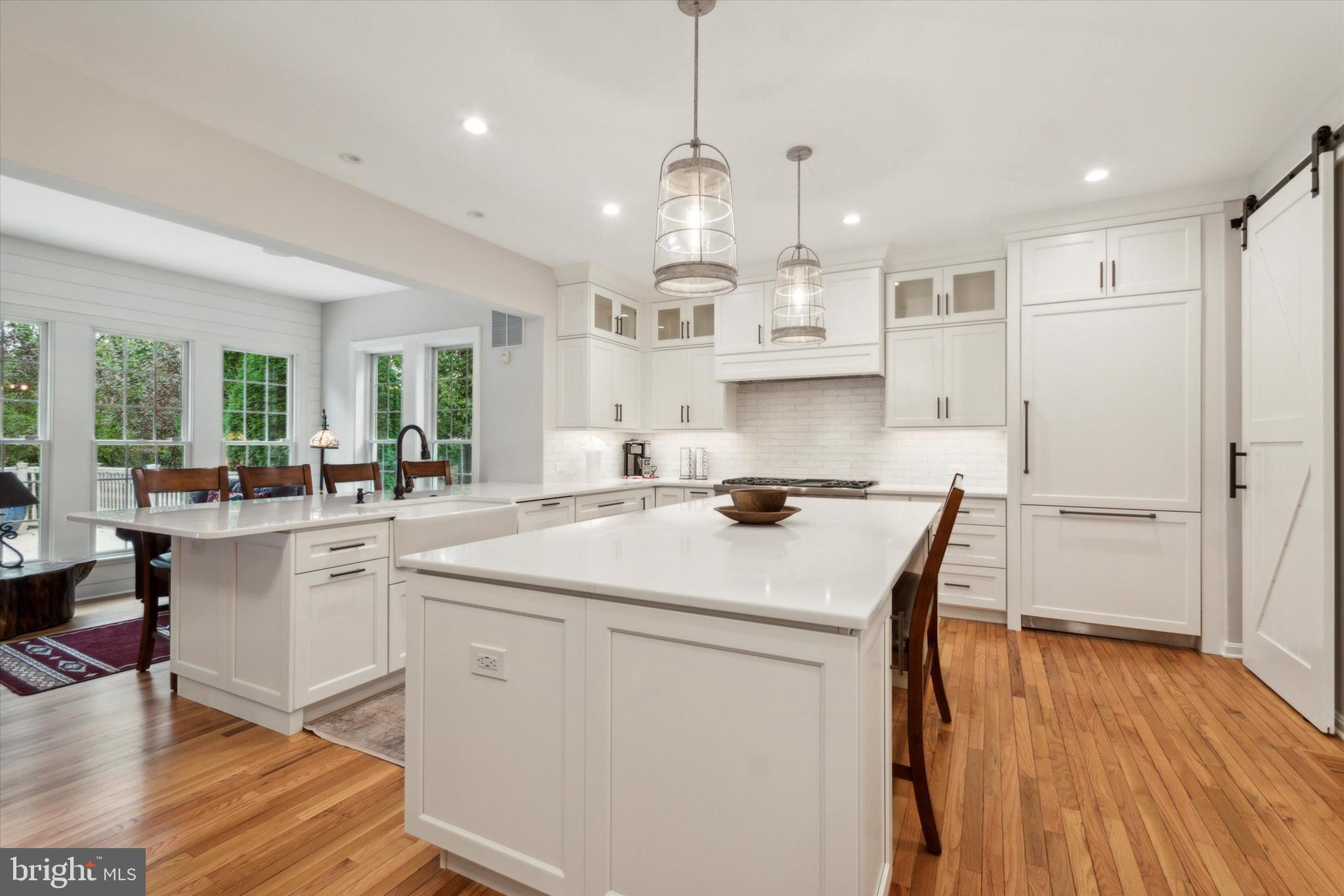 1007 Ridgehaven Road West Chester, PA 19382 - Photo 9 of 36 a kitchen that has a lot of white cabinets and wooden floor