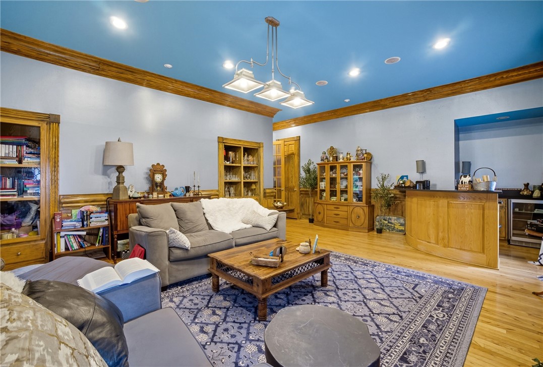 2328 Spindrift Road Virginia Beach, VA 23451 - Photo 16 of 50 Living room with wood finished floors, crown molding, wine cooler, and recessed lighting