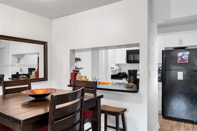 a view of a dining room with furniture and a chandelier