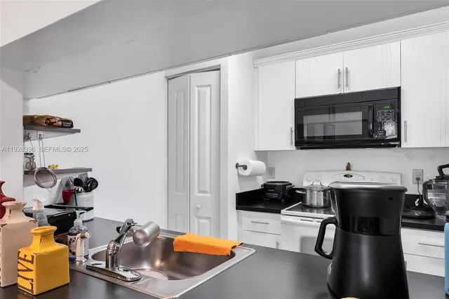 a kitchen with a sink cabinets and appliances