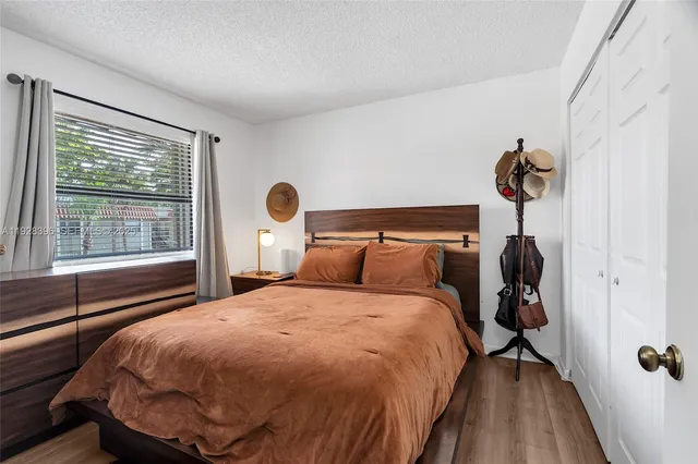 a bedroom with a bed and window
