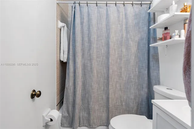 a white toilet sitting next to a bathroom sink