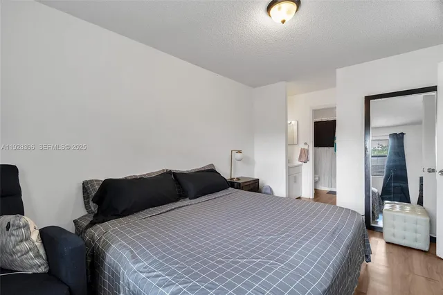 a bedroom with bed and a night stand