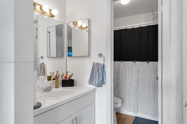 a bathroom with a sink vanity and mirror