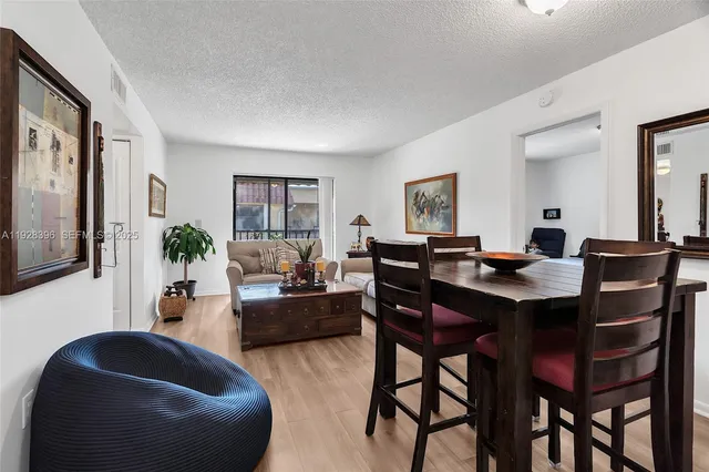 a living room with furniture potted plant and a table