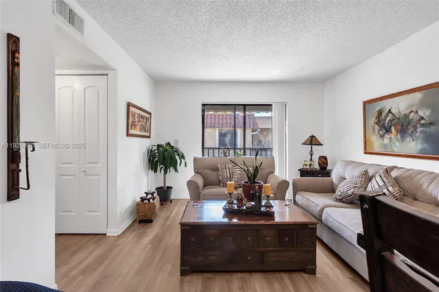 a living room with furniture or couch and a potted plant