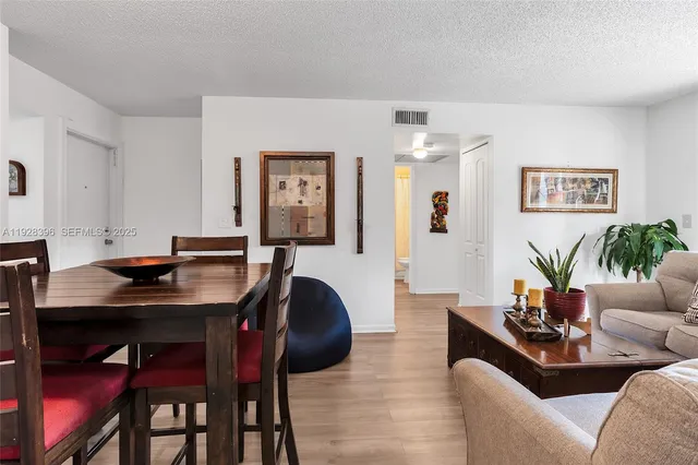 a living room with furniture and paintings on the wall