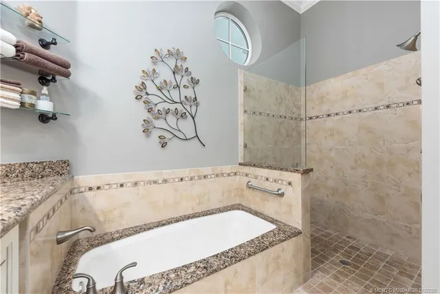 a bathroom with a bathtub and shower