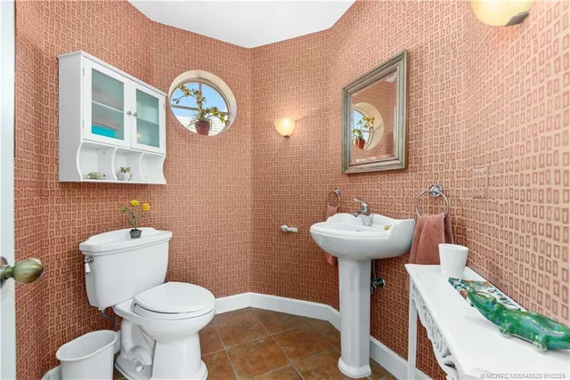 a bathroom with a sink mirror and toilet