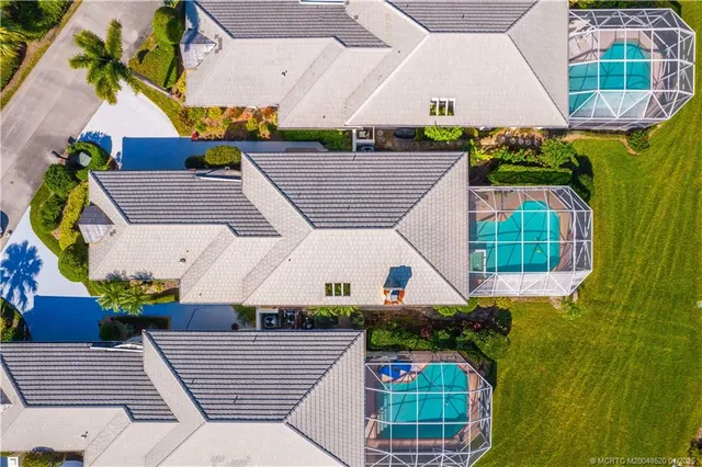 an aerial view of a house with a yard and potted plants