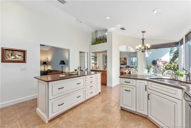 a kitchen with granite countertop a sink and cabinets