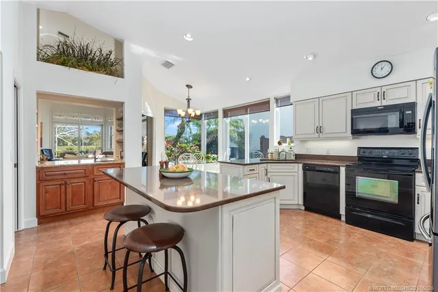 a kitchen with microwave a stove and cabinets