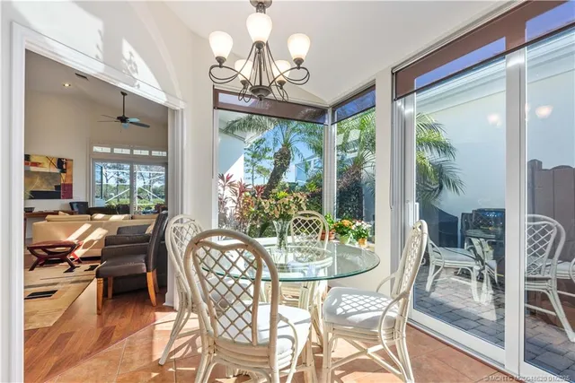 a view of a dining room with furniture wooden floor and chandelier