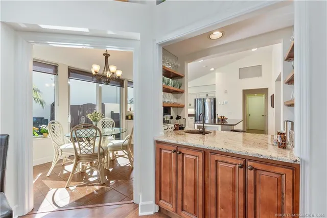 a bathroom with a granite countertop sink a mirror and a shower