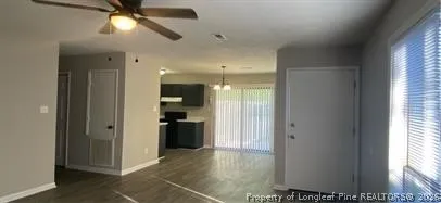 a view of a hallway with a dining table and a window