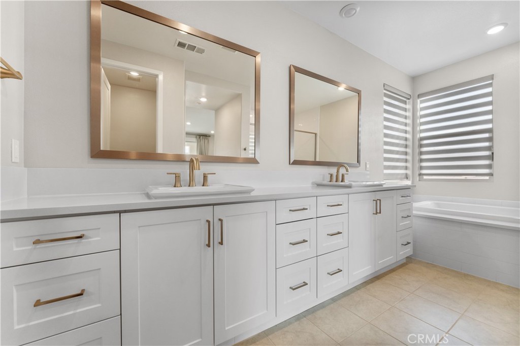 115 Rondo Irvine, CA 92618 - Photo 16 of 28 a bathroom with a granite countertop sink mirror and double