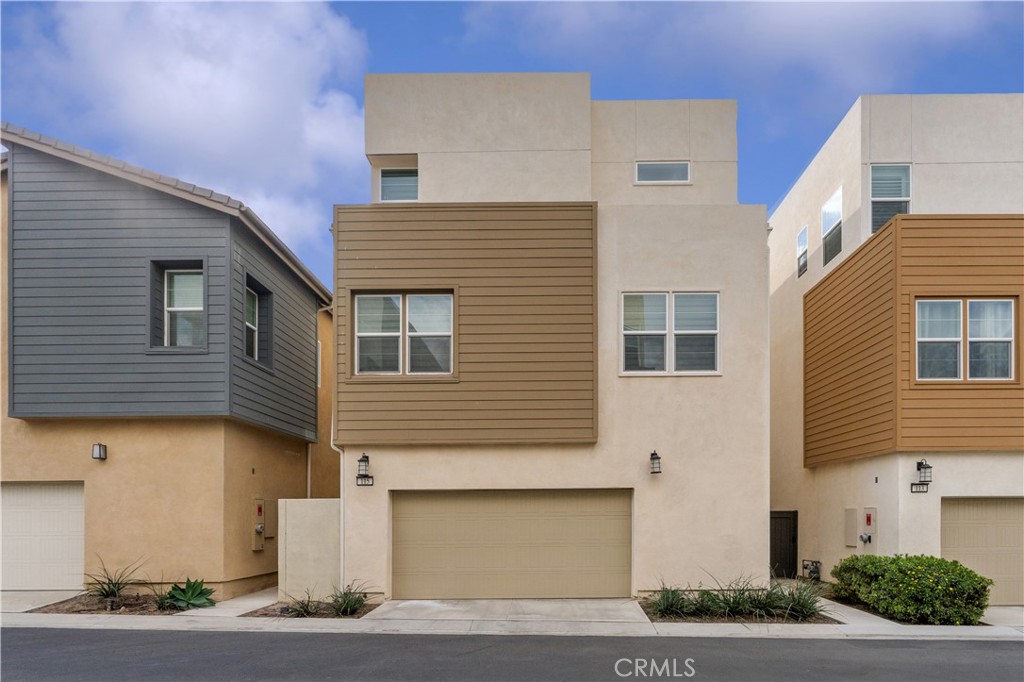 115 Rondo Irvine, CA 92618 - Photo 22 of 28 a front view of a house with garage and parking