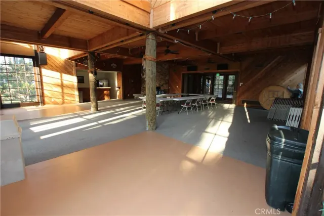 a view of a big yard with plants and large trees