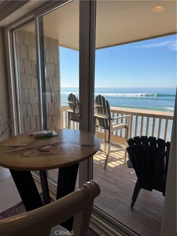 a kitchen with stainless steel appliances granite countertop a stove top oven a sink dishwasher a refrigerator and a microwave oven with wooden floor