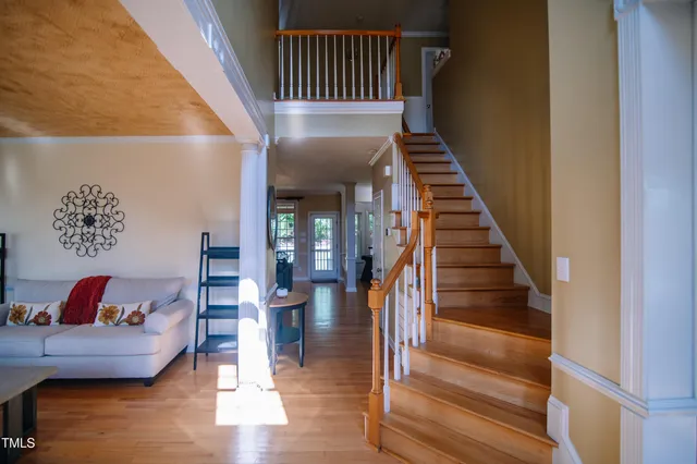 a view of entryway and hall with wooden floor