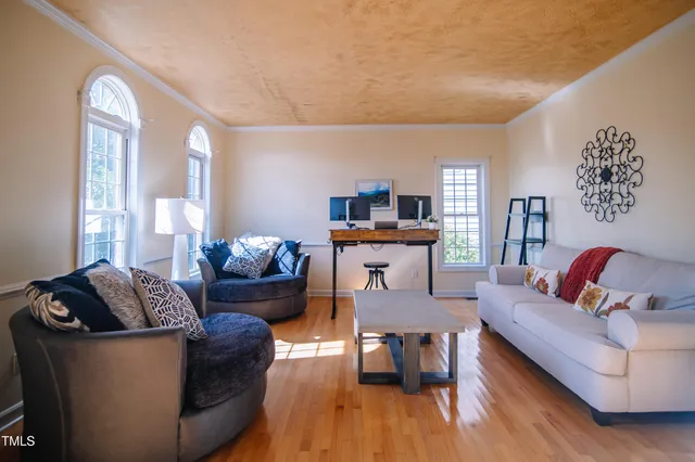 a living room with furniture and wooden floor