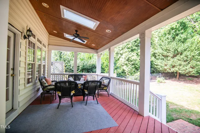 a view of a porch with furniture and a yard