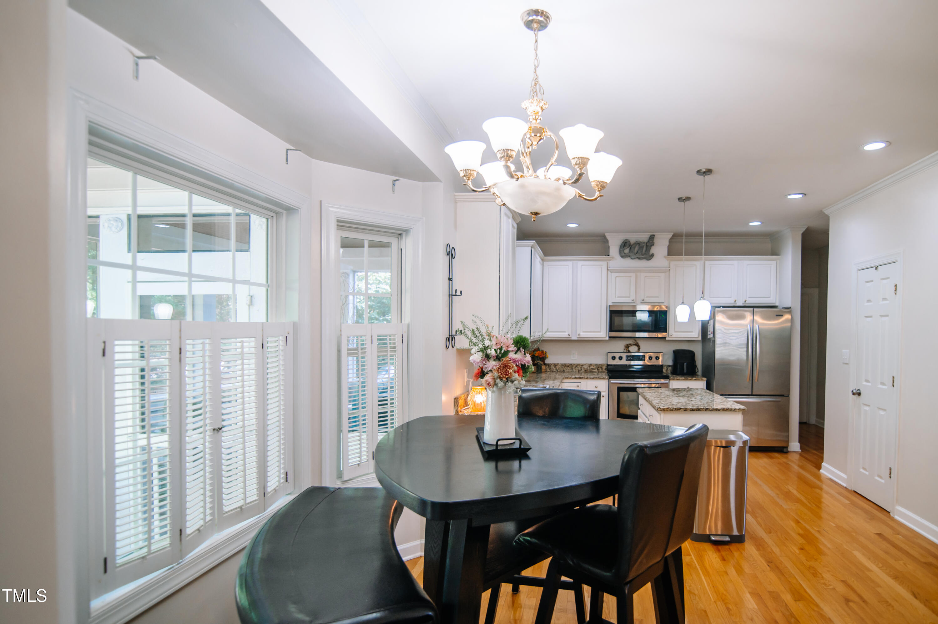 12223 Penrose Trail Raleigh, NC 27614 - Photo 3 of 21 a view of a dining room with furniture wooden floor and chandelier