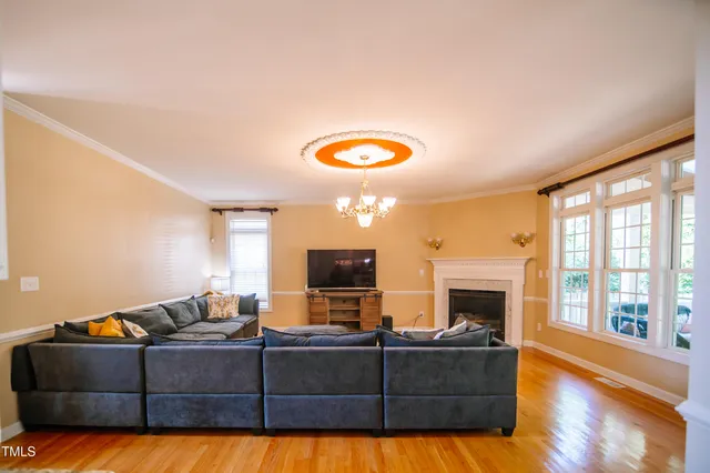 a living room with furniture fireplace and flat screen tv