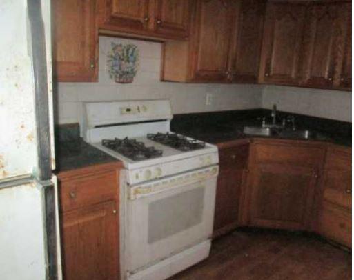 826 Parkwood Road Pittsburgh, PA 15210 - Photo 7 of 9 a kitchen with a stove and cabinets
