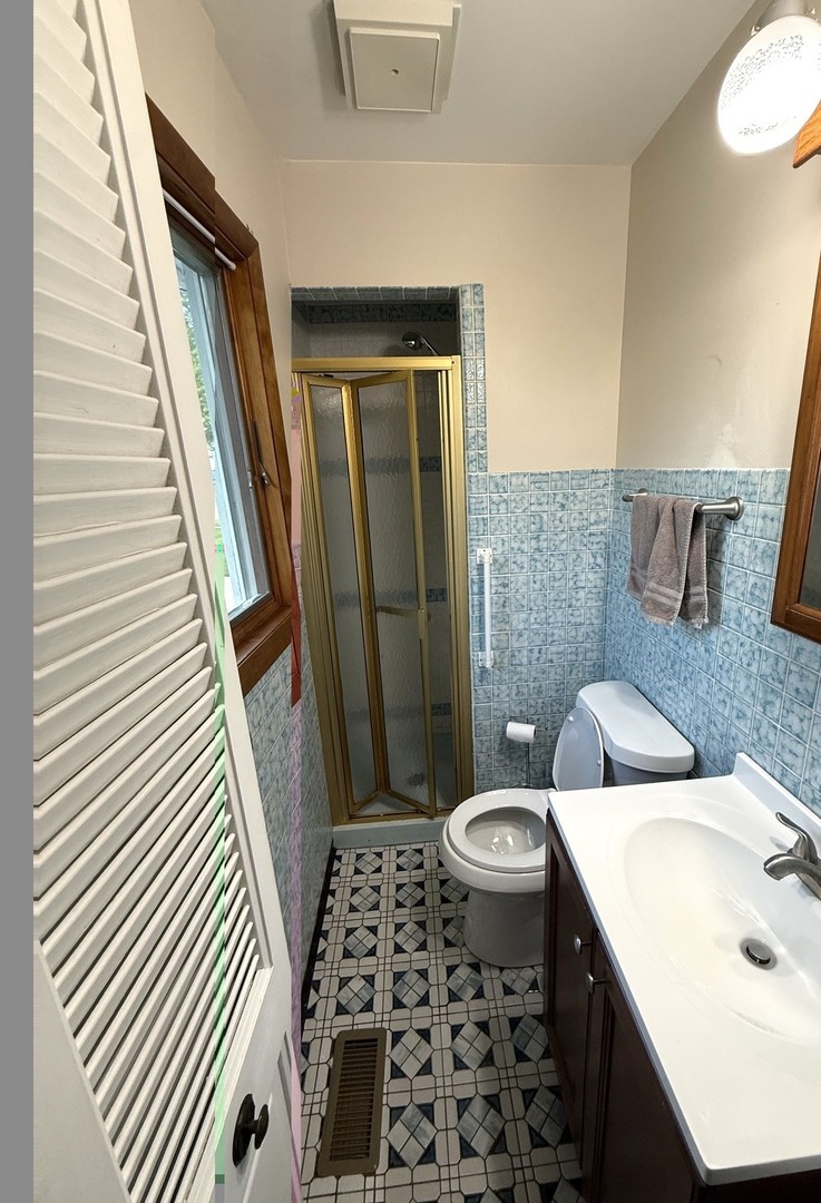 5199 Elmwood Road Oak Forest, IL 60452 - Photo 18 of 30 a bathroom with a sink a toilet a mirror and shower