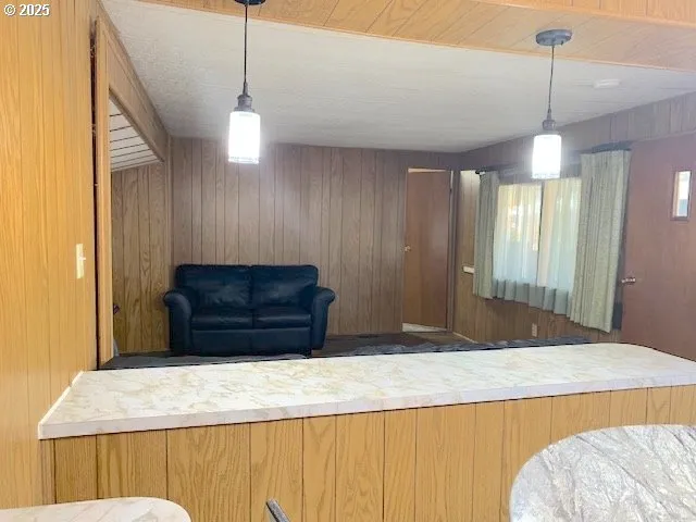 a kitchen with a refrigerator and ceiling fan