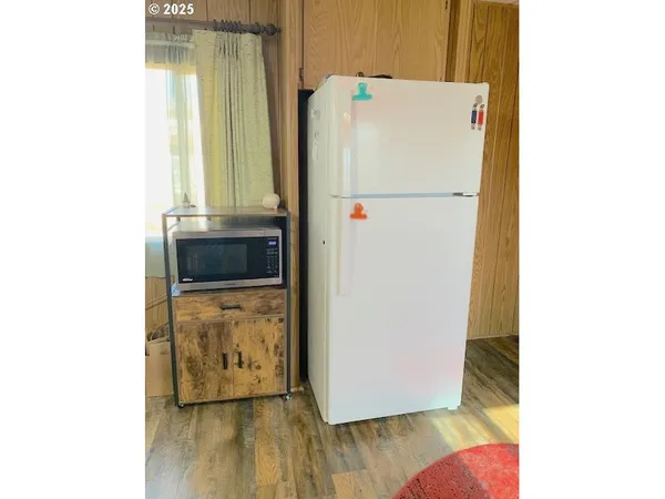 a white refrigerator freezer sitting inside of a kitchen