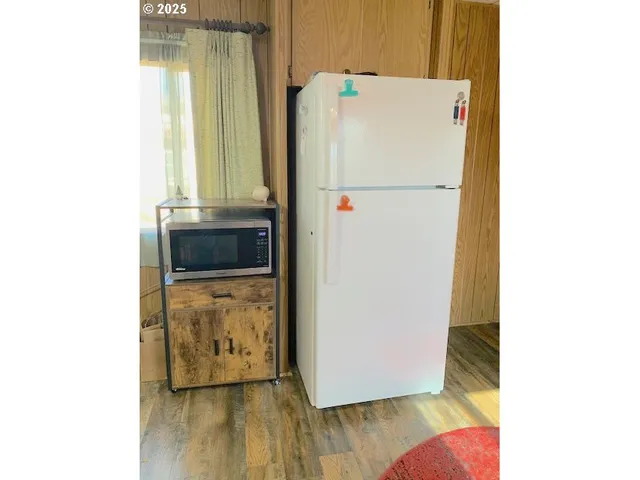 a white refrigerator freezer sitting inside of a kitchen