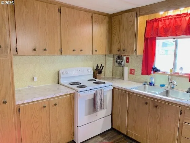 a kitchen with a sink stove and cabinets