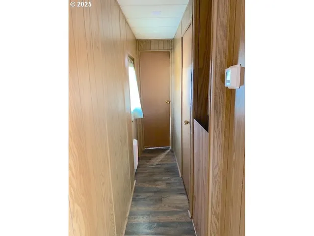 a view of a hallway with wooden floor