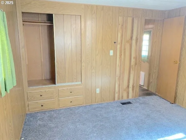 a view of an empty room with wooden door