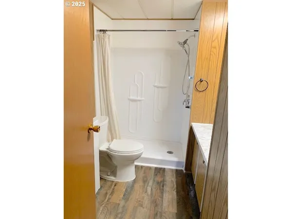 a bathroom with a toilet and a shower