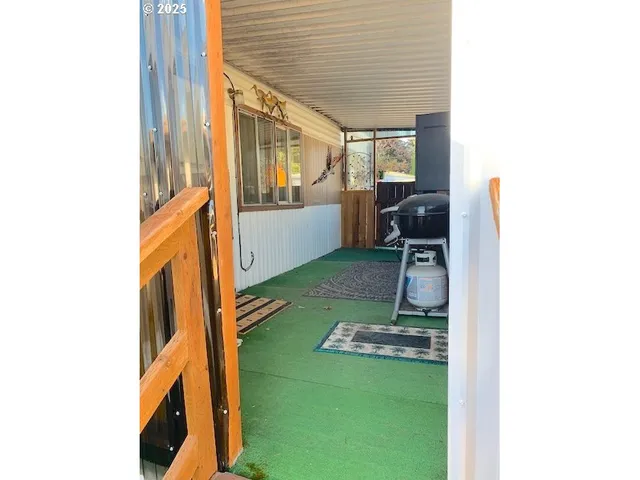 a view of living room with furniture and a fireplace