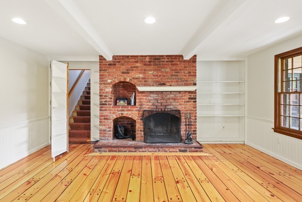 17 Bittersweet Lane Wilbraham, MA 01095 - Photo 13 of 40 a view of a livingroom with wooden floor and a fireplace