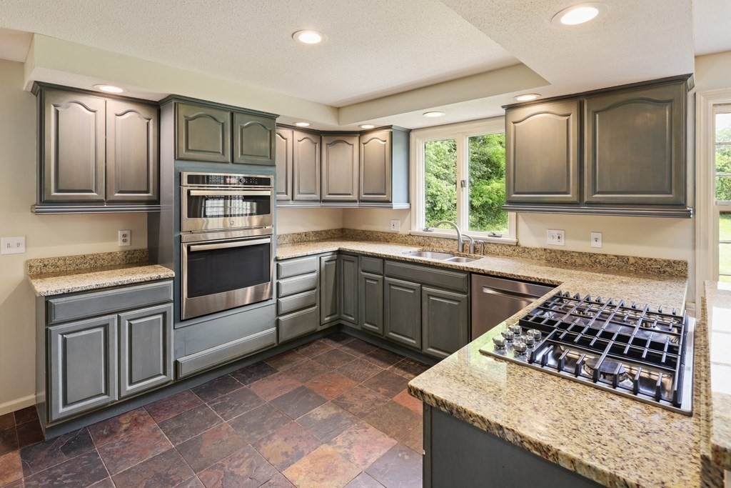 17 Bittersweet Lane Wilbraham, MA 01095 - Photo 15 of 40 a kitchen with a stove a sink and a refrigerator