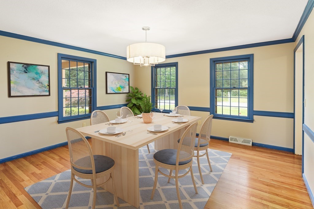 17 Bittersweet Lane Wilbraham, MA 01095 - Photo 17 of 40 a dining room with wooden floor a chandelier a wooden table and chairs