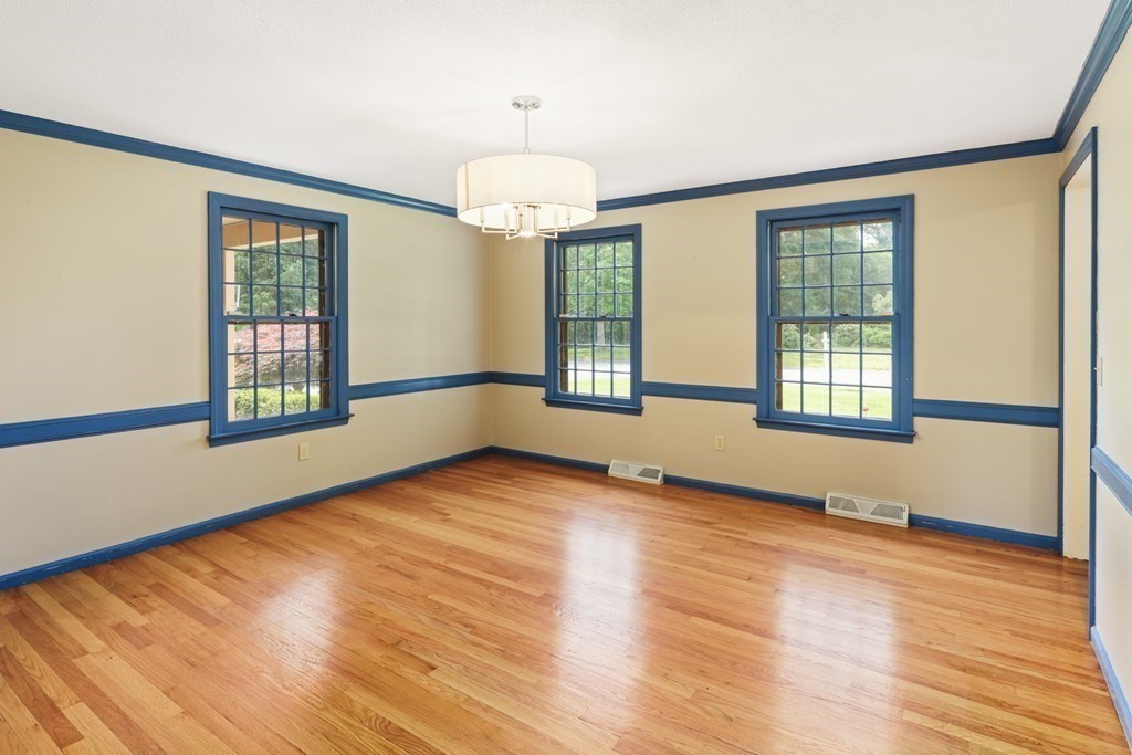 17 Bittersweet Lane Wilbraham, MA 01095 - Photo 18 of 40 a view of an empty room with wooden floor and a window