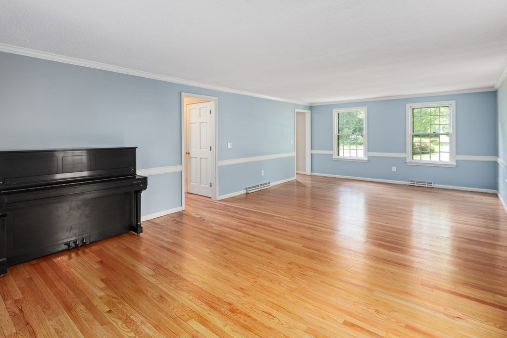 17 Bittersweet Lane Wilbraham, MA 01095 - Photo 22 of 40 a view of empty room with wooden floor and fan