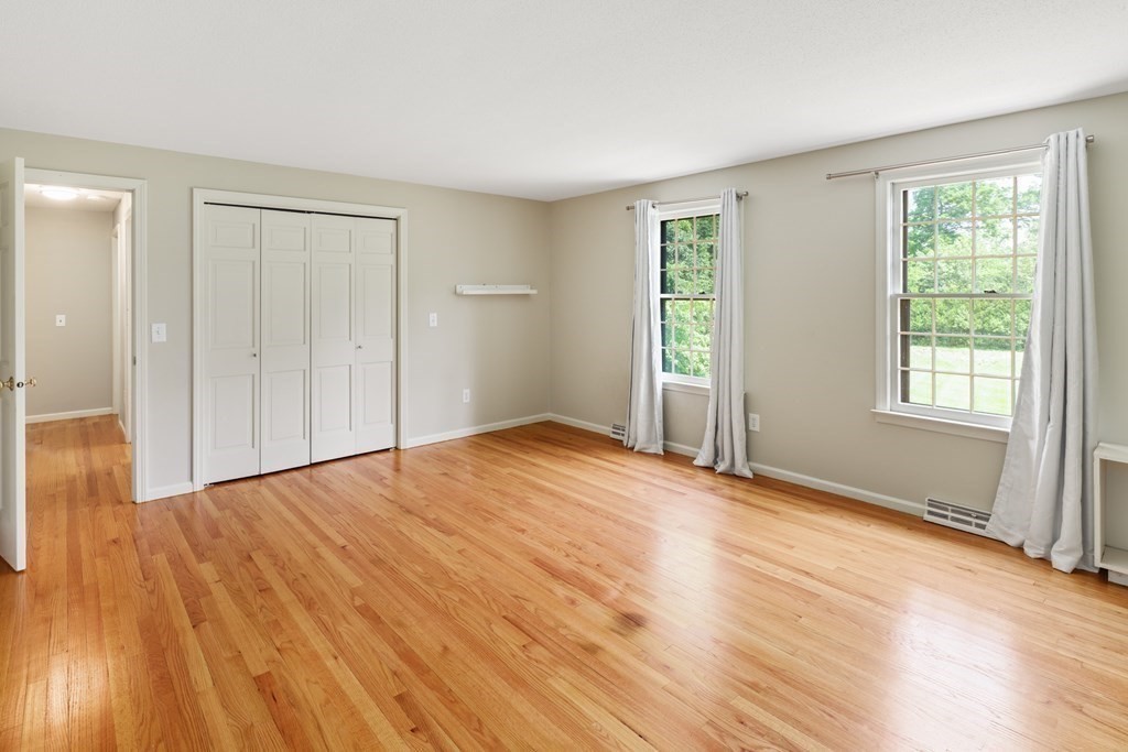 17 Bittersweet Lane Wilbraham, MA 01095 - Photo 25 of 40 a view of an empty room with wooden floor and a window