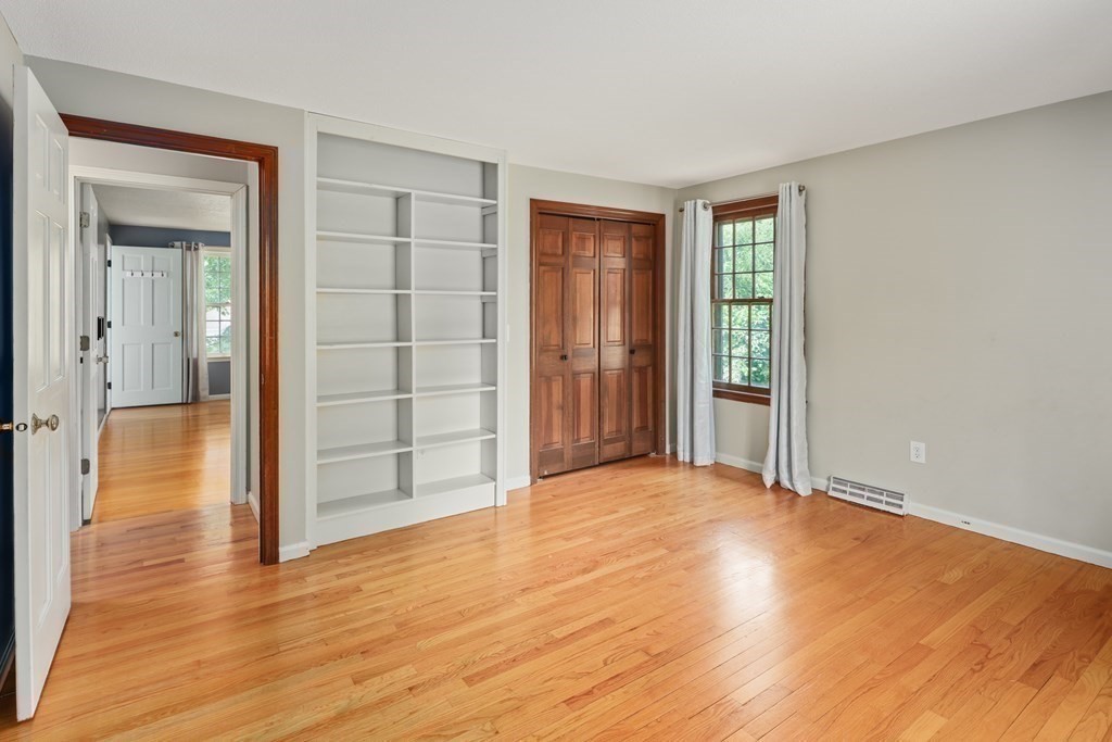 17 Bittersweet Lane Wilbraham, MA 01095 - Photo 31 of 40 a view of an empty room with wooden floor and a window